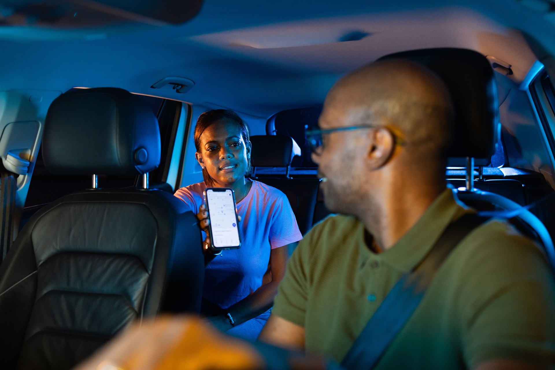 Young woman showing a location to the taxi driver