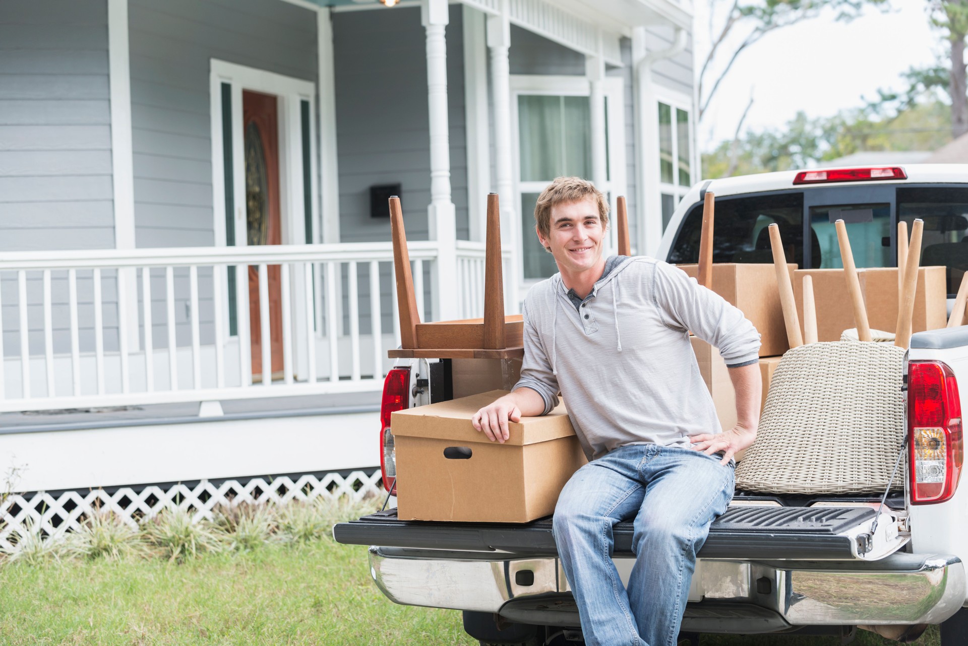 Young man with pickup, moving his belongings